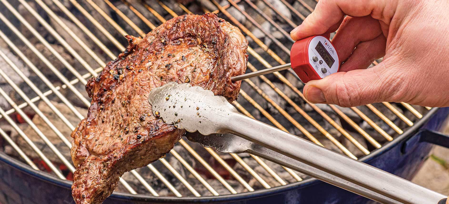 checking meat with a thermometer