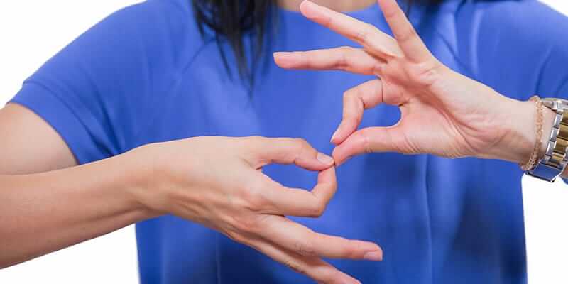 American Sign Language (ASL) woman interpreter showing her hands
