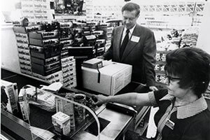 Wegmans Fairport Store in 1974 Robert Wegman watching clerk scan UPC codes at checkout